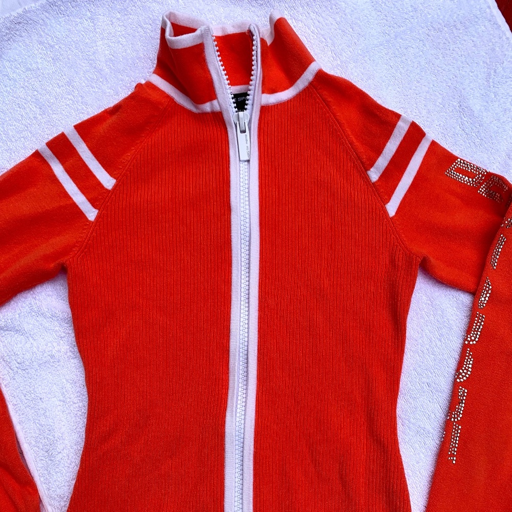 Brand New Bebe Long Sleeve Zip Up Sweater with rhinestones logo (NWOT)